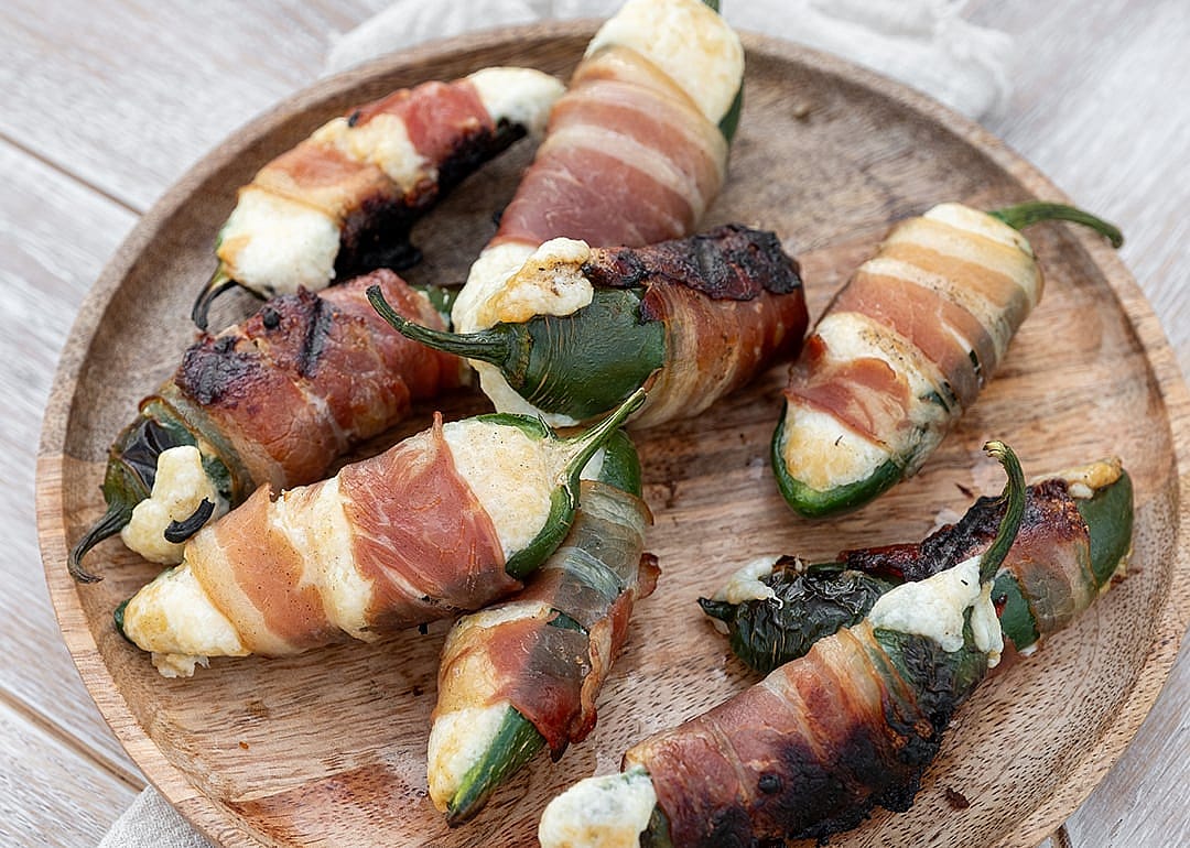 Spicy jalapeno peppers stuffed with cream cheese and wrapped in bacon
